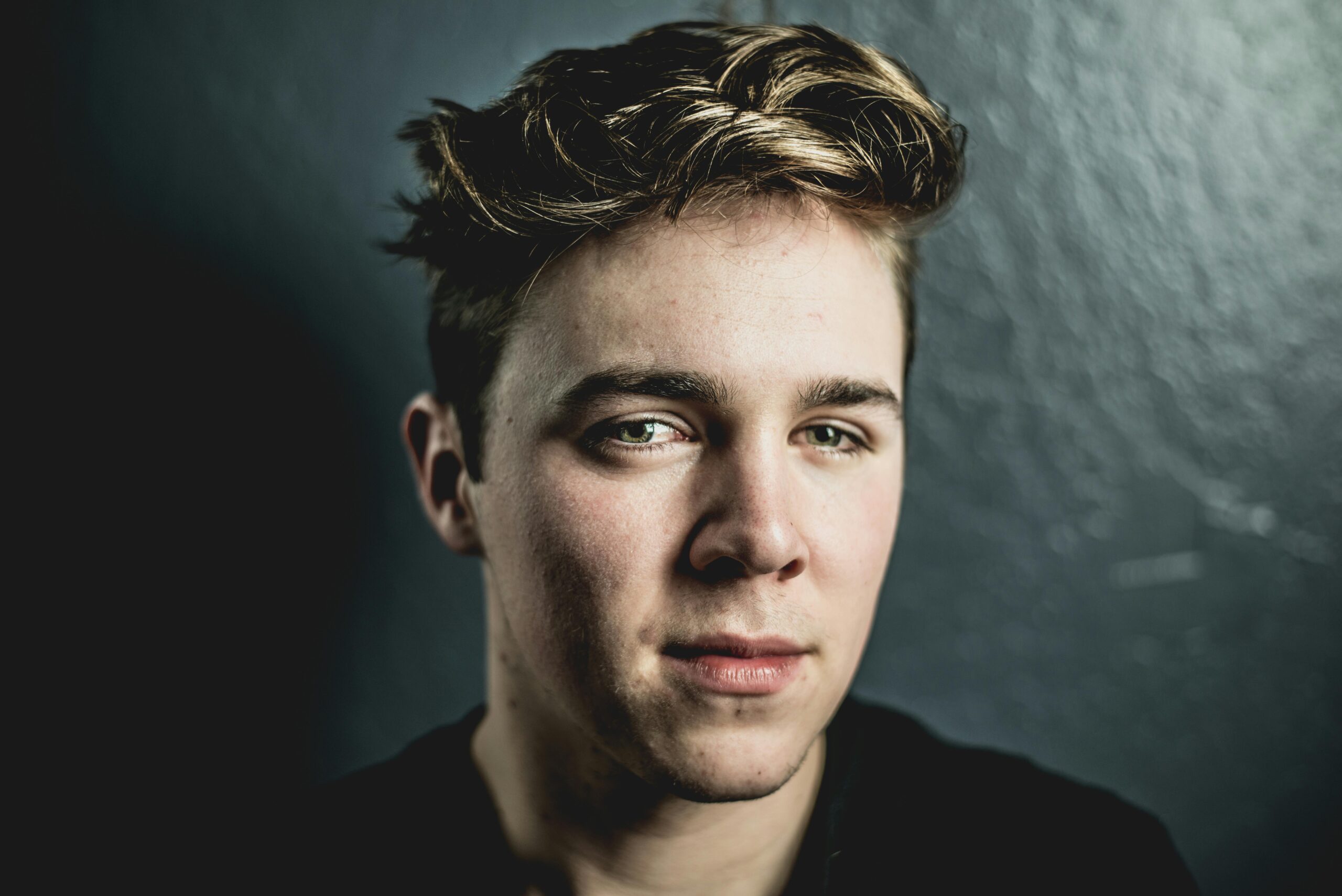 Intimate portrait capturing the thoughtful expression of a young man.